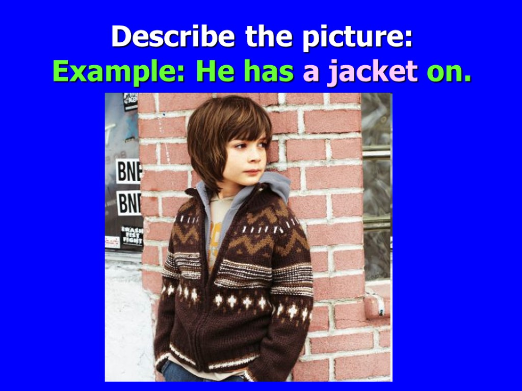 Describe the picture: Example: He has a jacket on.